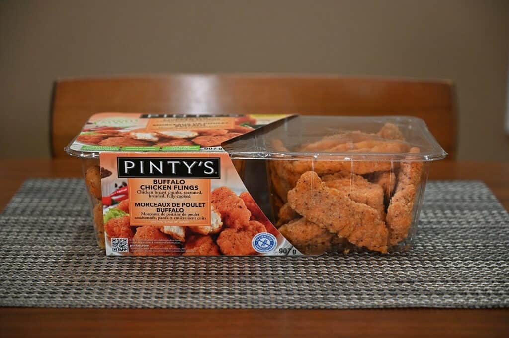 Side view image of the Costco Pinty's Buffalo Chicken Flings sitting on a table. 