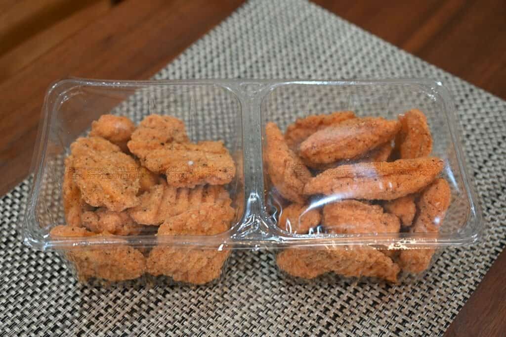 Costco Pinty's Buffalo Chicken Flings in packaging, two pack plastic tray on a grey placemat. 