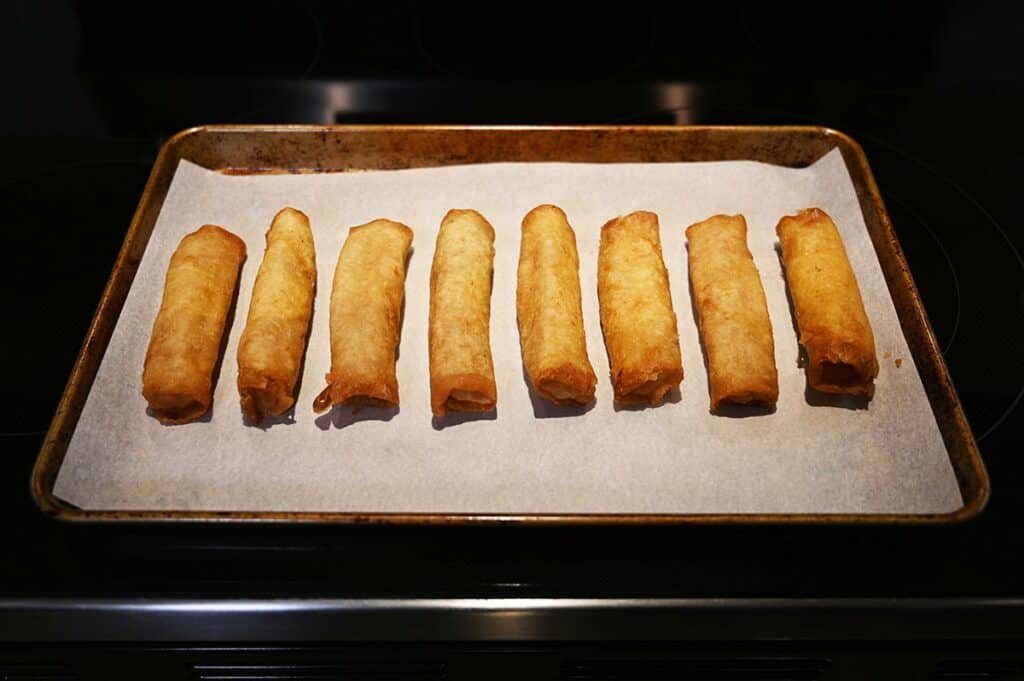 Costco Summ! Apple Pie Rolls baking in the oven on a cookie sheet. 