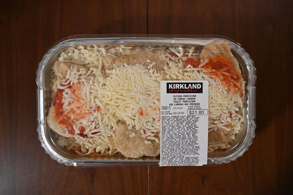 Costco Kirkland Signature Chicken Parmigiana on Cheese Lasagna in container with lid on sitting on a table