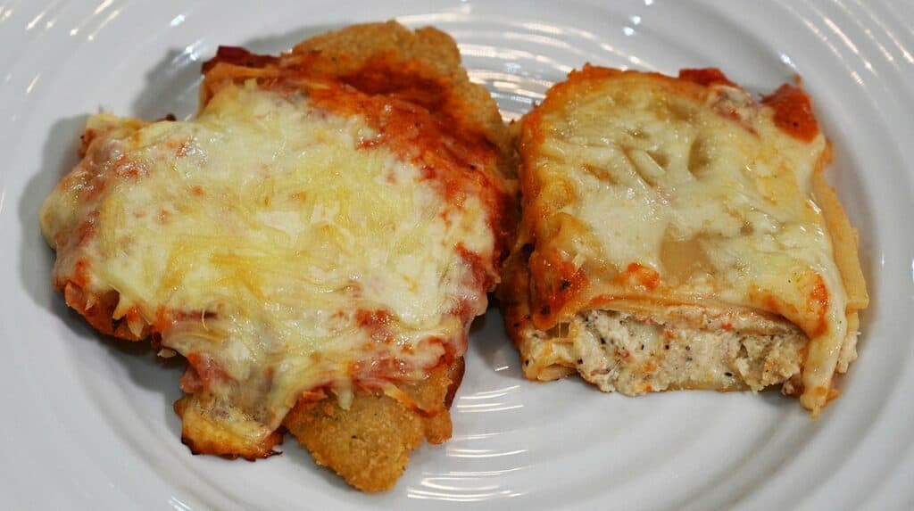 Costco Kirkland Signature Chicken Parmigiana on Cheese Lasagna cooked and on a white plate