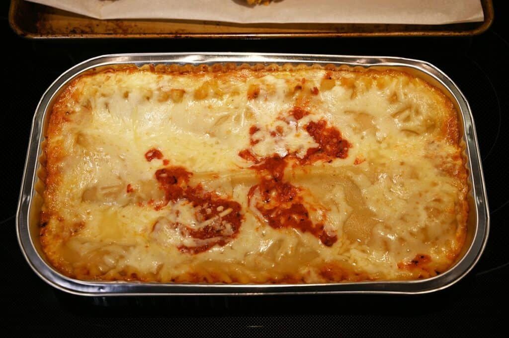Costco Kirkland Signature Chicken Parmigiana on Cheese Lasagna lasagna cooking in the oven. 