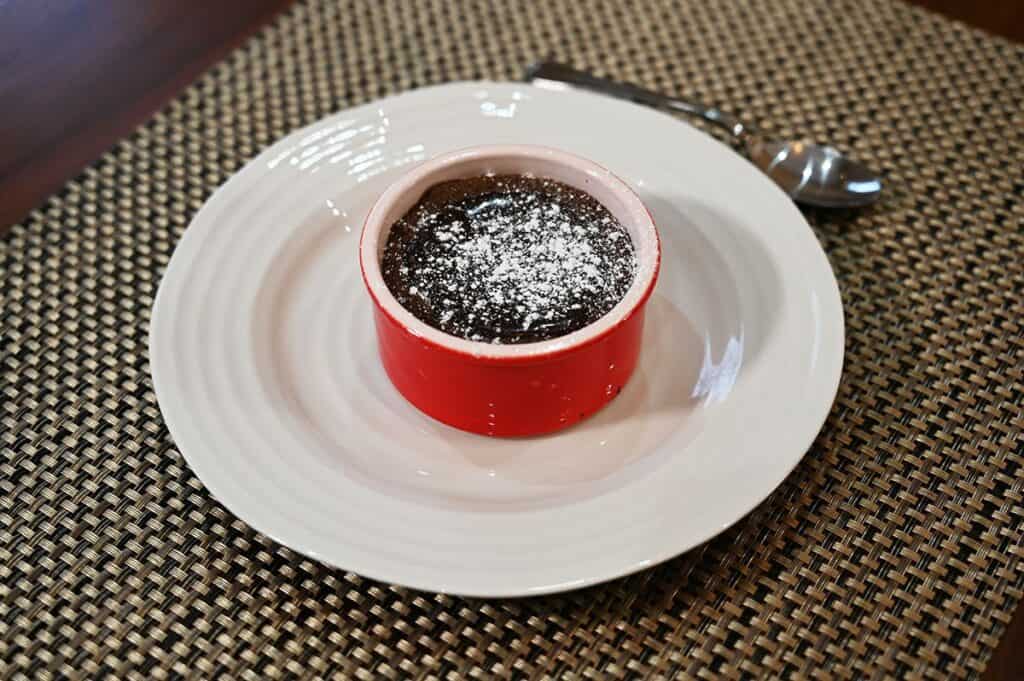 Costco Delici Belgian Chocolate Soufflé served on a white plate with a dusting of icing sugar after heating. 