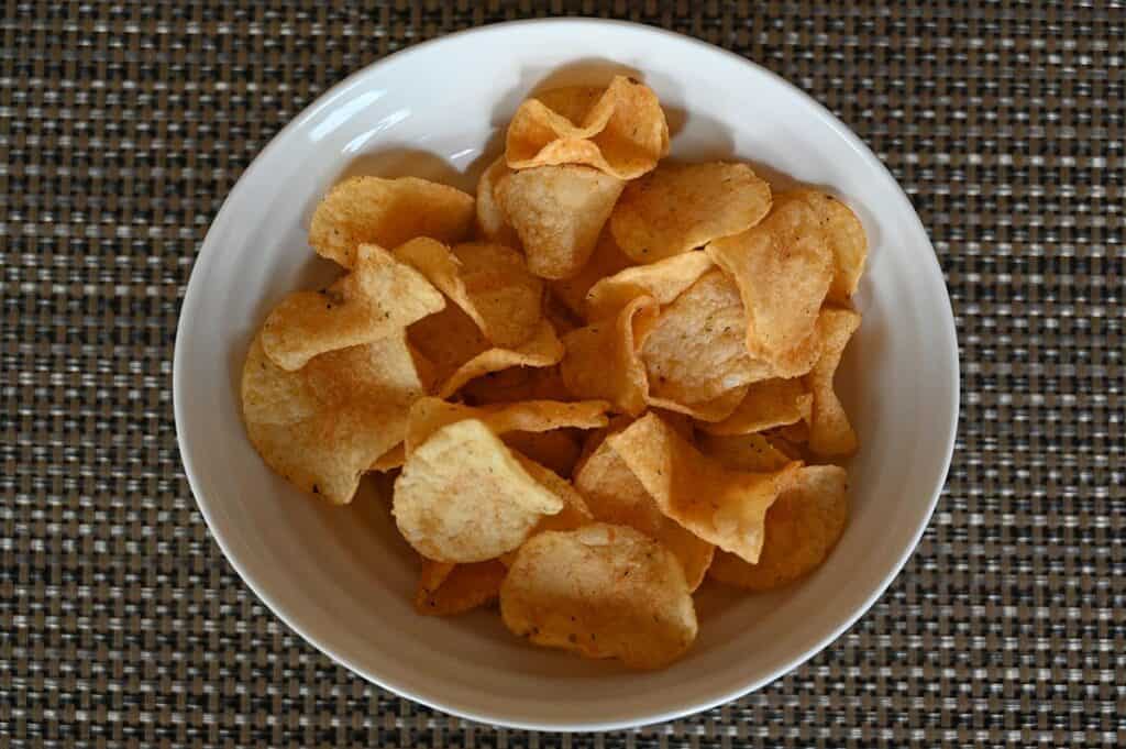 Costco Miss Vickie's Spicy Dill Pickle Chips poured into a white bowl. 