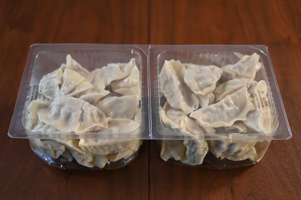 Costco Summ! Sesame Ginger Chicken Gyoza Dumplings two pack outside cardboard removed with eighteen dumplings in each plastic section. 