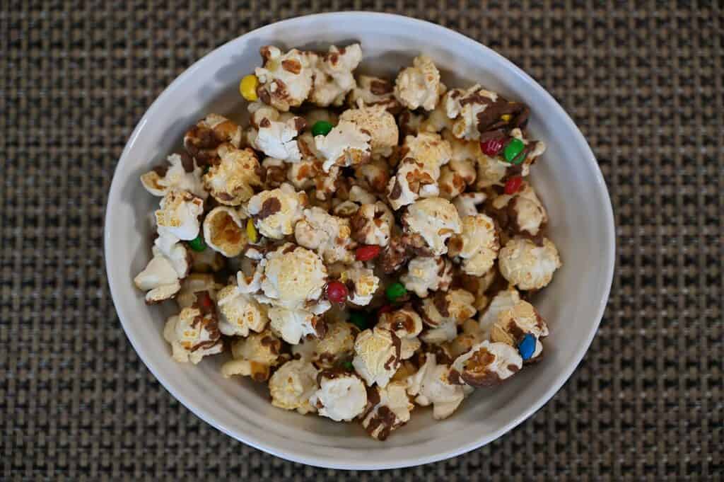 Costco Candy Pop Popcorn M&M's Minis poured into a white bowl, top down view. 