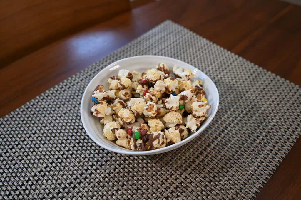 Costco Candy Pop Popcorn M&M's Minis poured into a bowl and sitting on a table. 