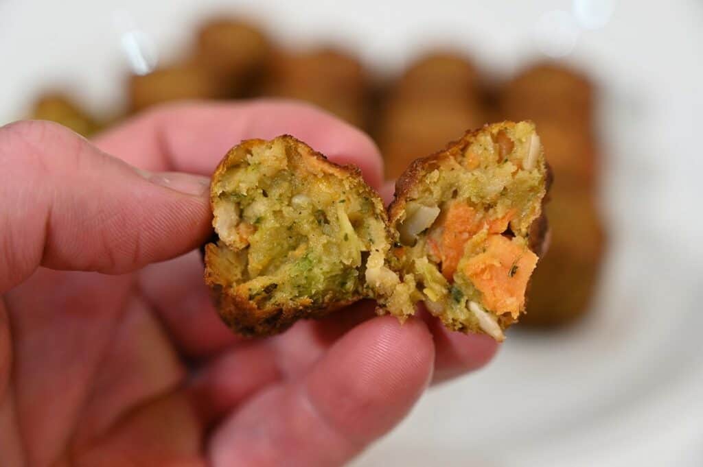 Close up image of the middle of of one  Costco Don Lee Farms Organic Veggie Bite with veggie bites on a white plate in the background. 