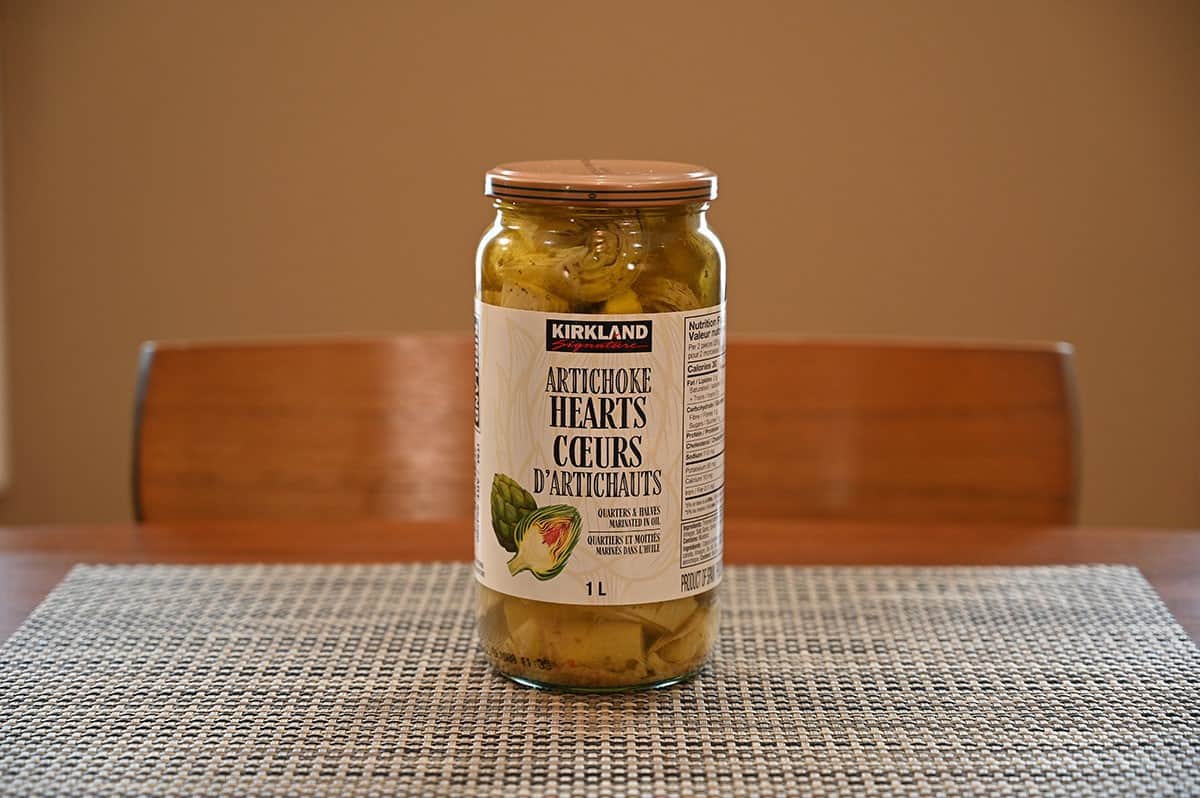 Costco Kirkland Signature Artichoke Hearts jar sitting on a table.