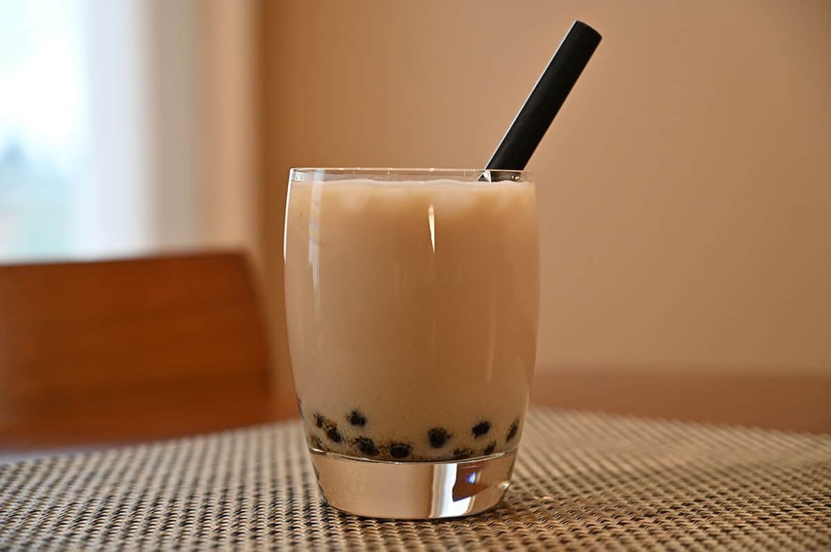 Costco Boba Bam Instant Boba Pack prepared and mixed with milk in a glass with a straw in the glass. 