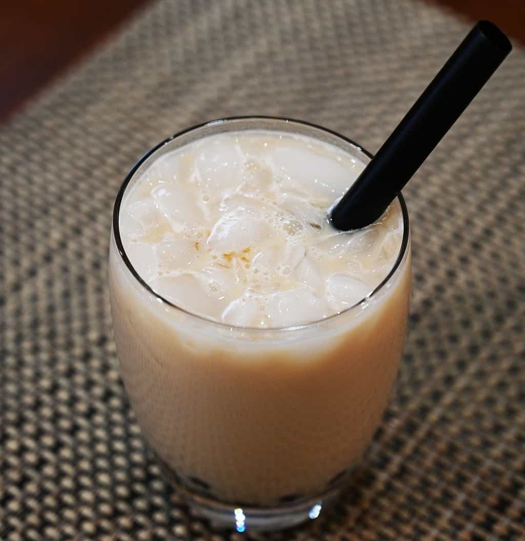 Costco Boba Bam Instant Boba Pack prepared and mixed with milk in a glass with a straw in the glass. Image of the top of the glass.