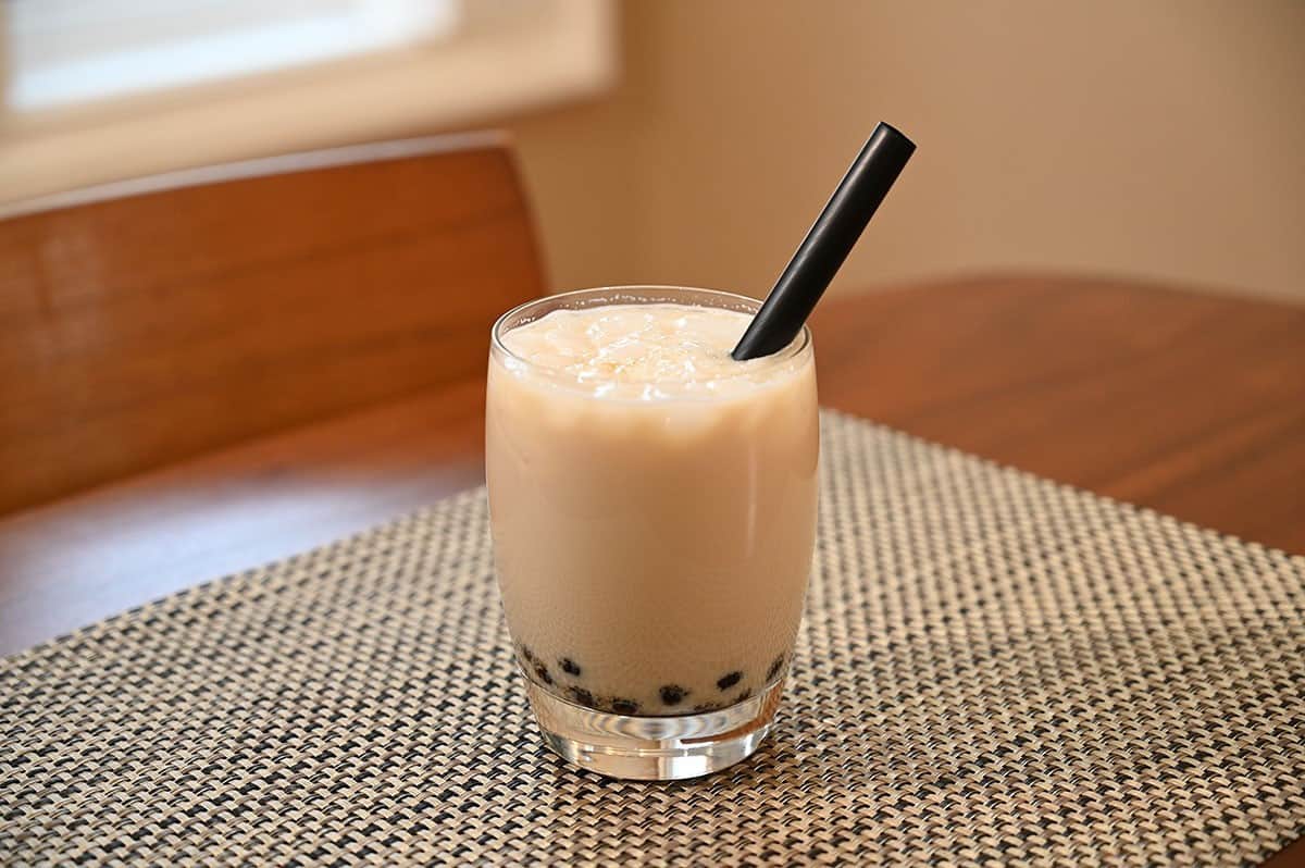 Costco Boba Bam Instant Boba Pack prepared and mixed with milk in a glass with a straw in the glass. 