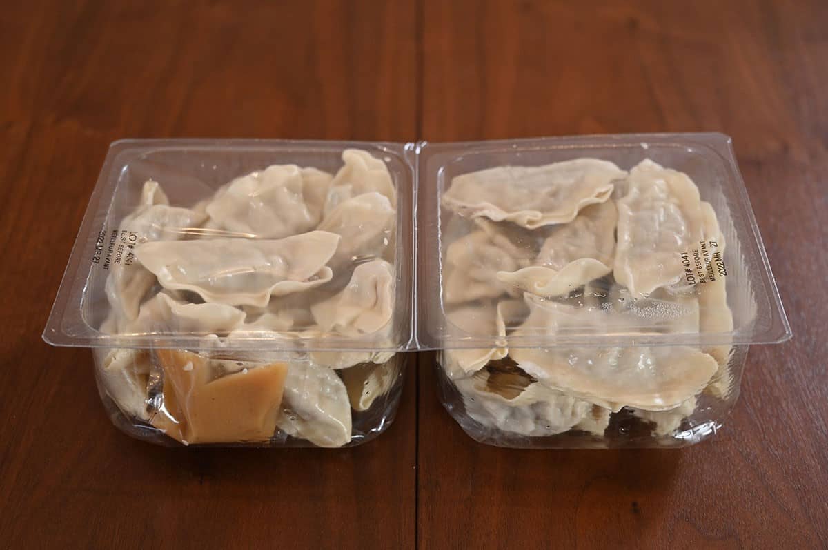 Image of dumplings in the plastic two-pack with eighteen in each pack and two sauce packets. 