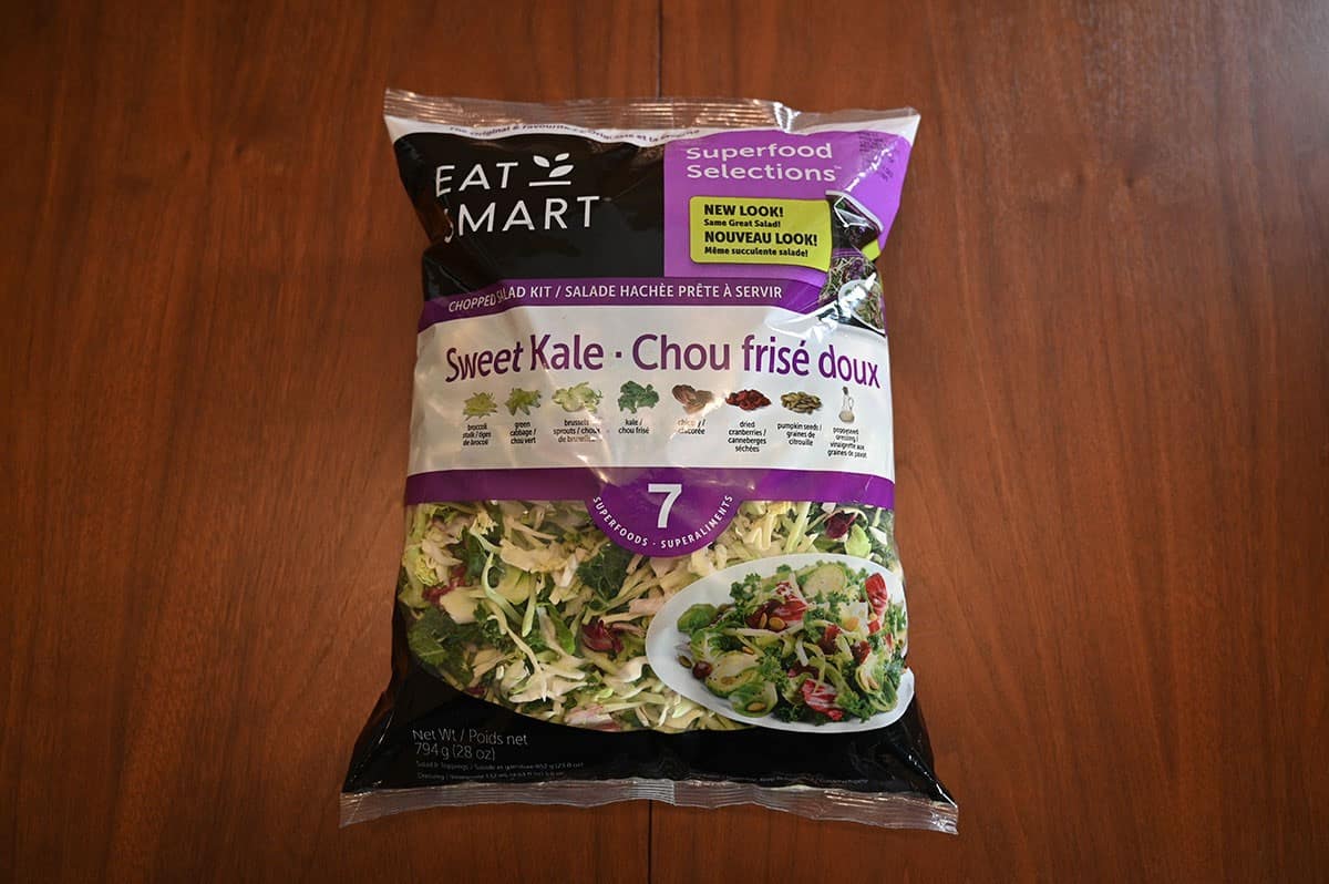 Costco kale salad kit 794 gram bag sitting on a table. 