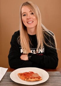 Natalie with Kirkland Signature shirt and Costco pizza