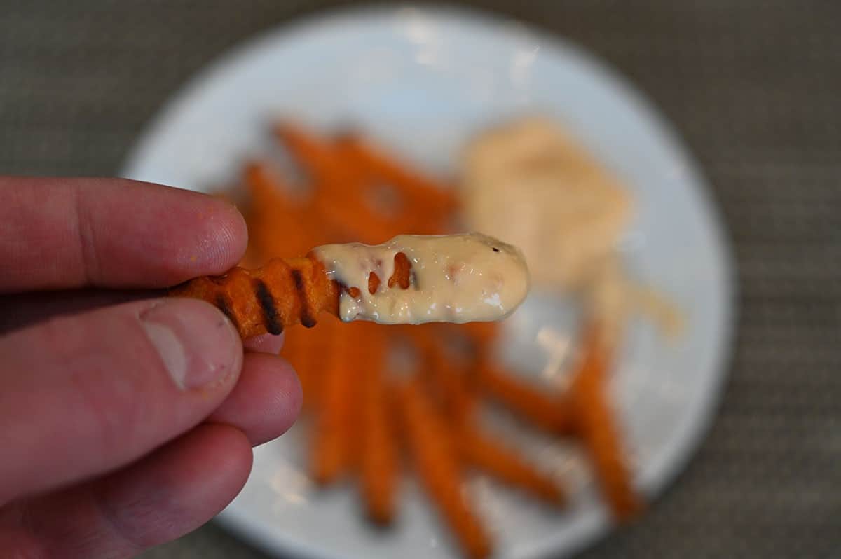 Closeup image of jalapeno lime aioli on one sweet potato fry. 