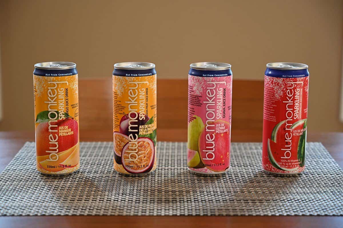 Image of the four kinds of Blue Monkey Sparkling Juice Drink cans on a table. 