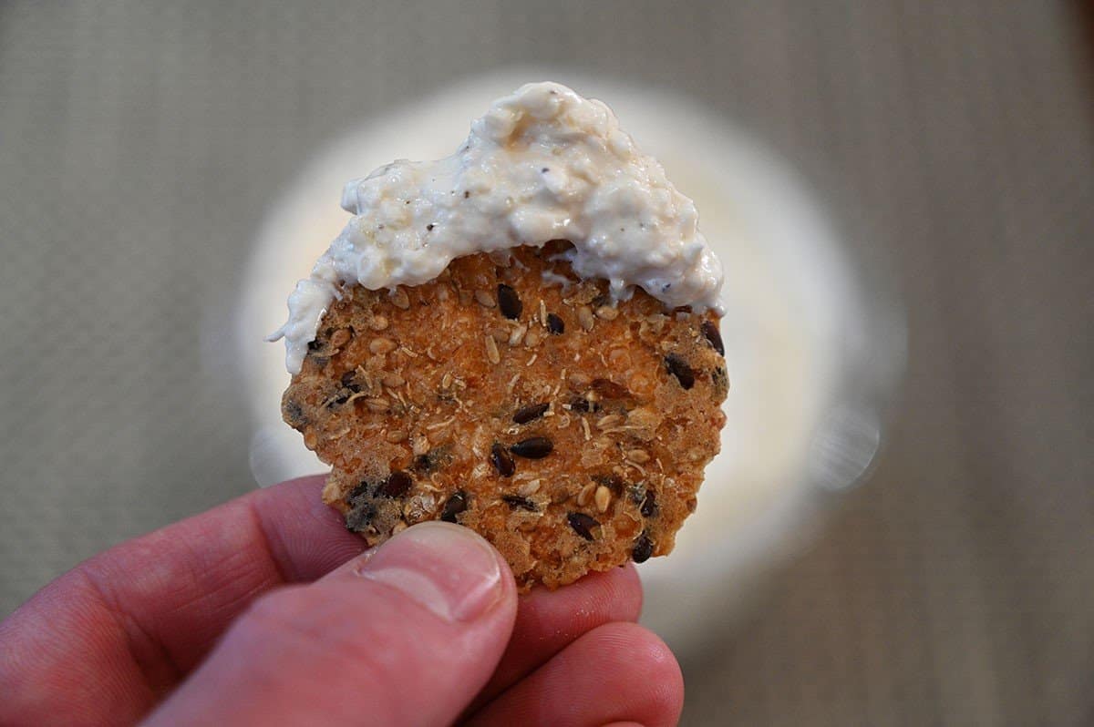 Closeup image of the Costco Good Foods Caramelized Onion & Gruyere Cheese Dip on a cracker. 