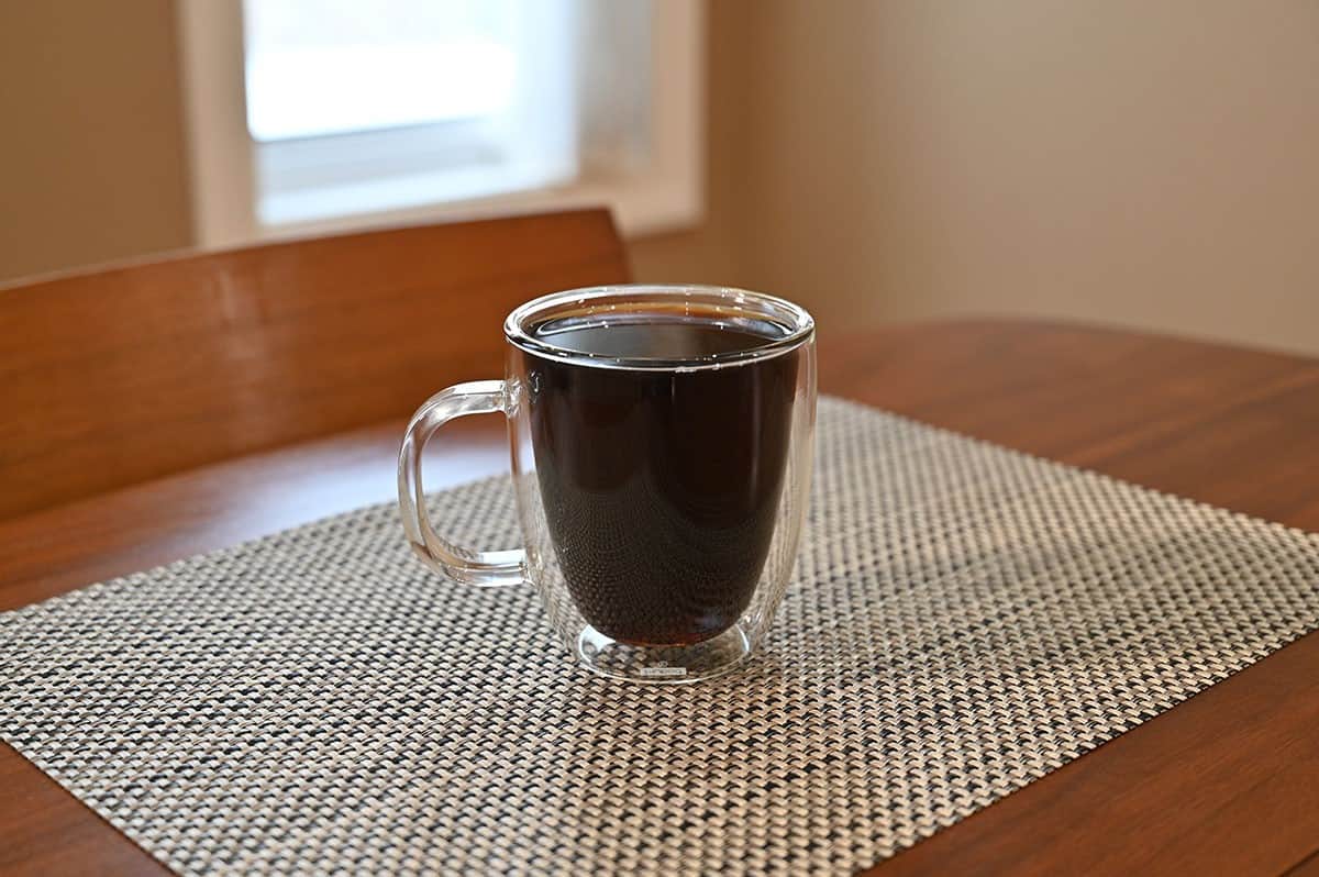 Image of a brewed cup of coffee on a table. 