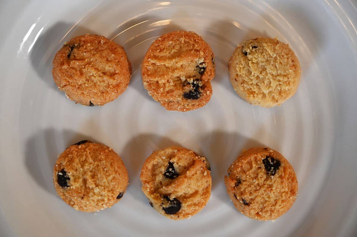 Closeup image of six HighKey Mini Cookies on a white plate. 