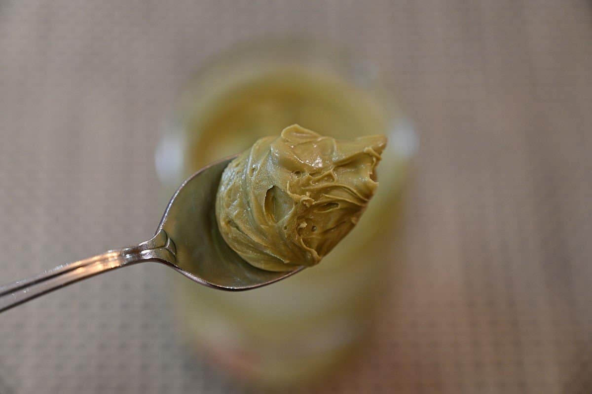 Closeup image of the Costco Pisti Spreadable Pistachio Cream on a spoon. 