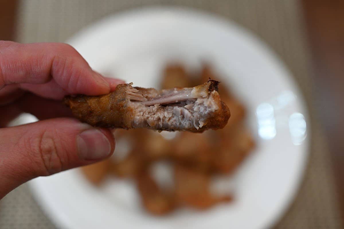 Image of one garlic dry rib with a bite taken out of it so you can see the inside. 