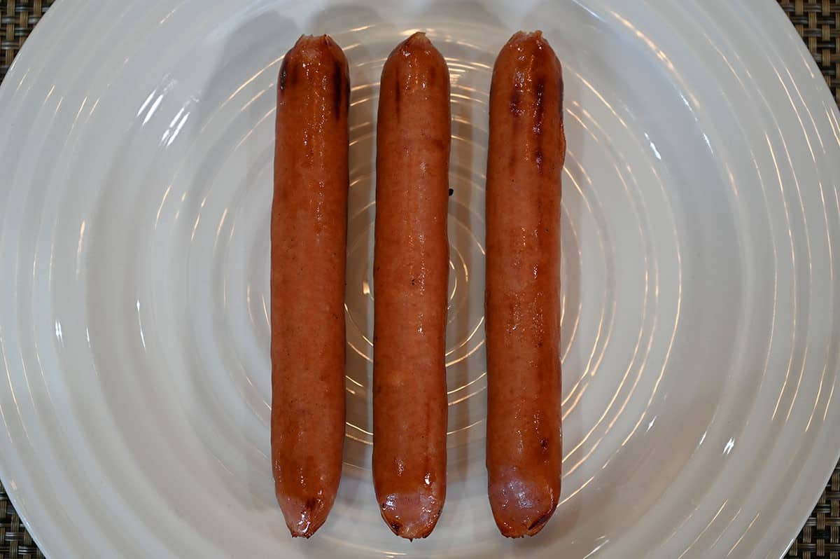 Three Costco Siwin Japanese Style Sausages on a plate after being barbecued. 
