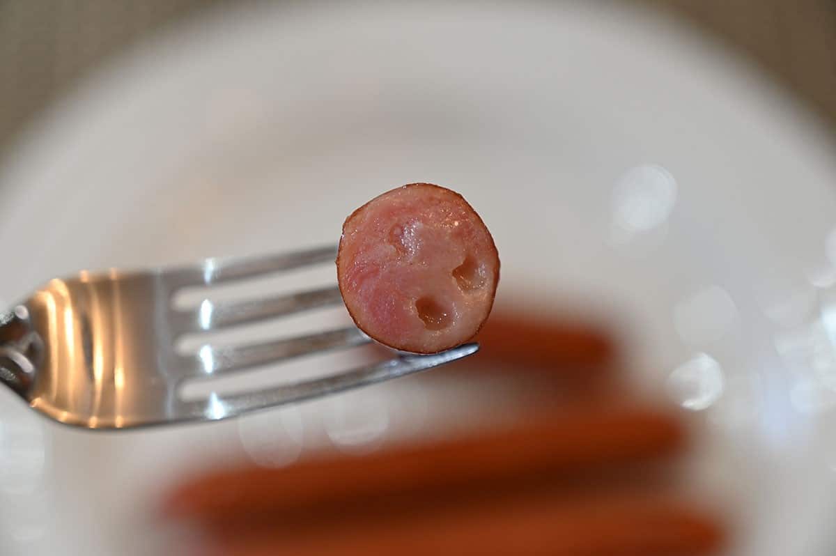 Closeup image of one Costco Siwin Japanese Style Sausage bitten into 