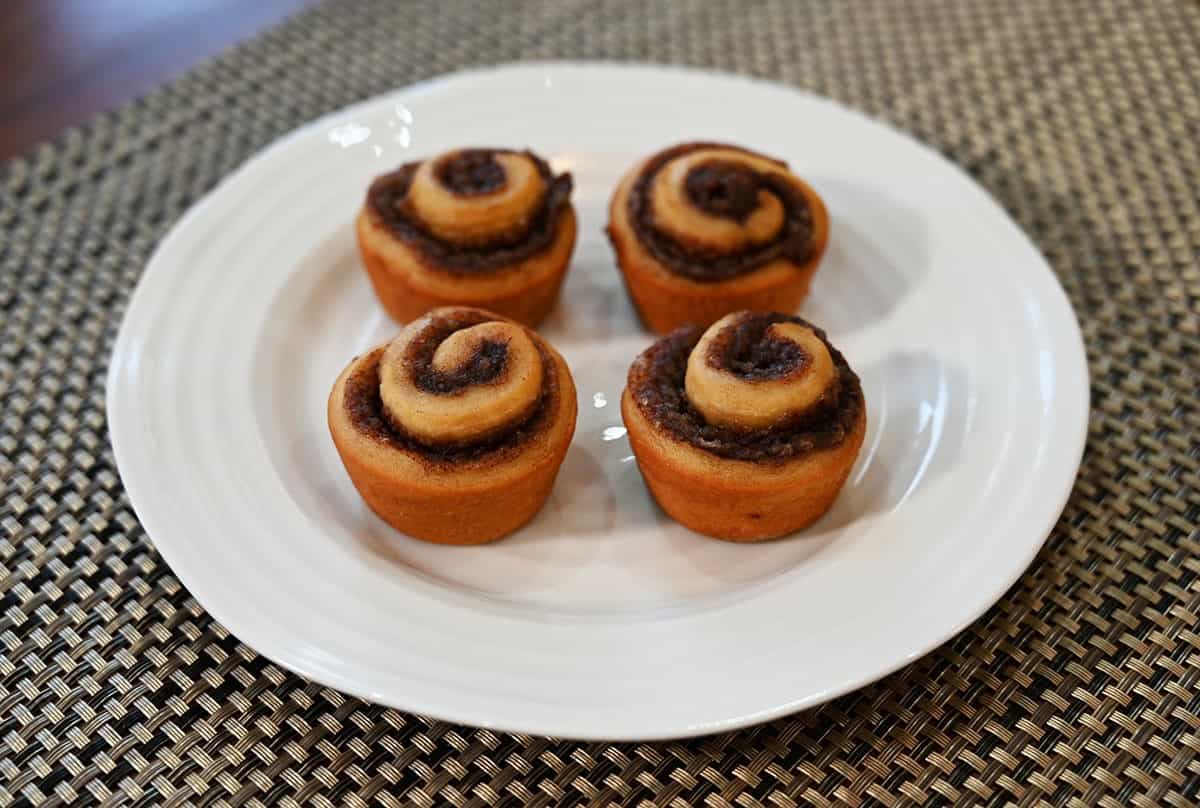 Four Costco Universal Bakery Petite Cinnamon Rolls on a white plate. 