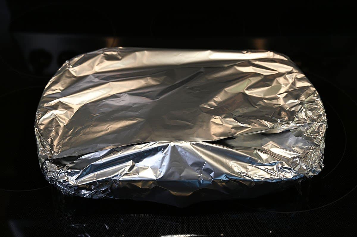 Image of the baking dish covered in aluminum foil, 
