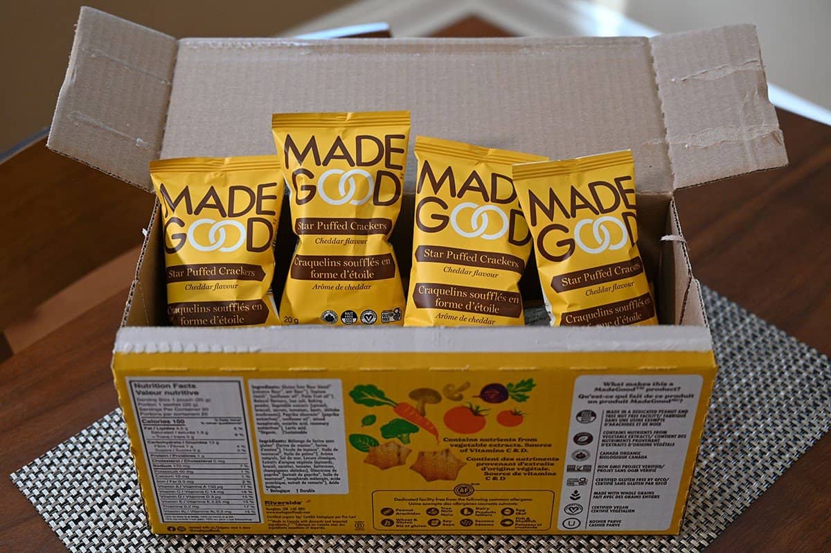 Image of the box of Costco MadeGood Star Puffed Crackers opened showing what the individual packets look like. 