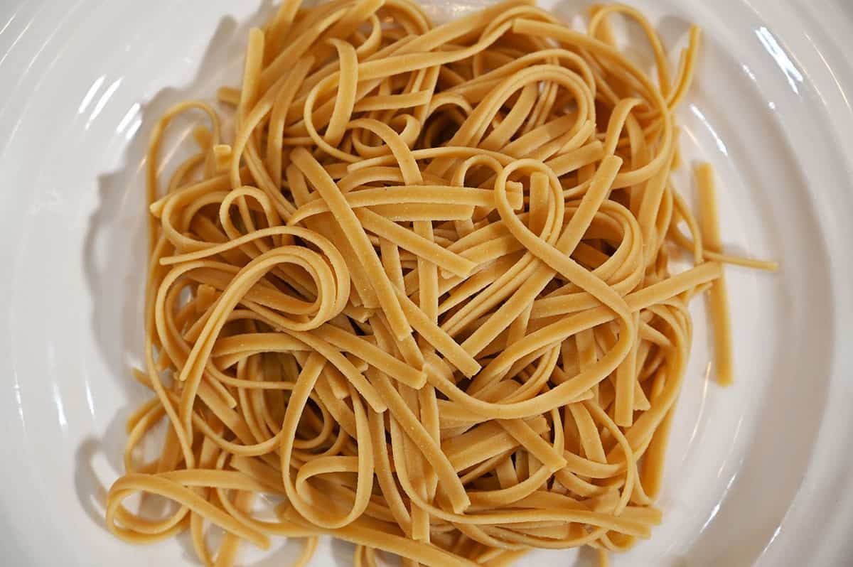 Image of Costco Pedon Four Bean Linguini cooked and plain without sauce, on a white plate, close up image. 