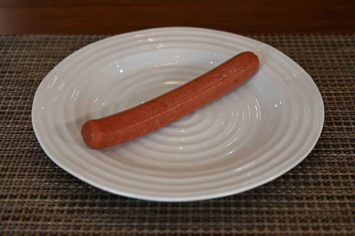 Costco Kirkland Signature Beef Polish Sausage before cooking it, on a white plate. 