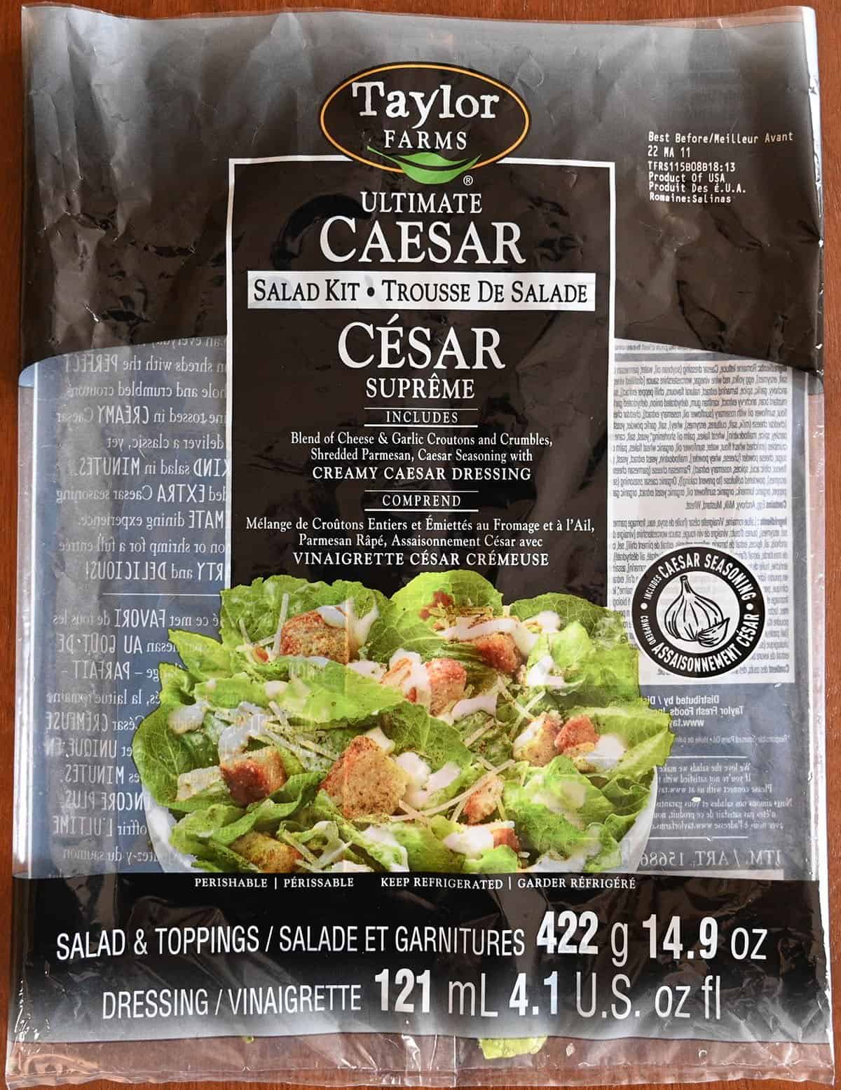 Empty and flattened Costco Taylor Farms Ultimate Caesar Salad Kit bag on a table so you can read the bag better. 