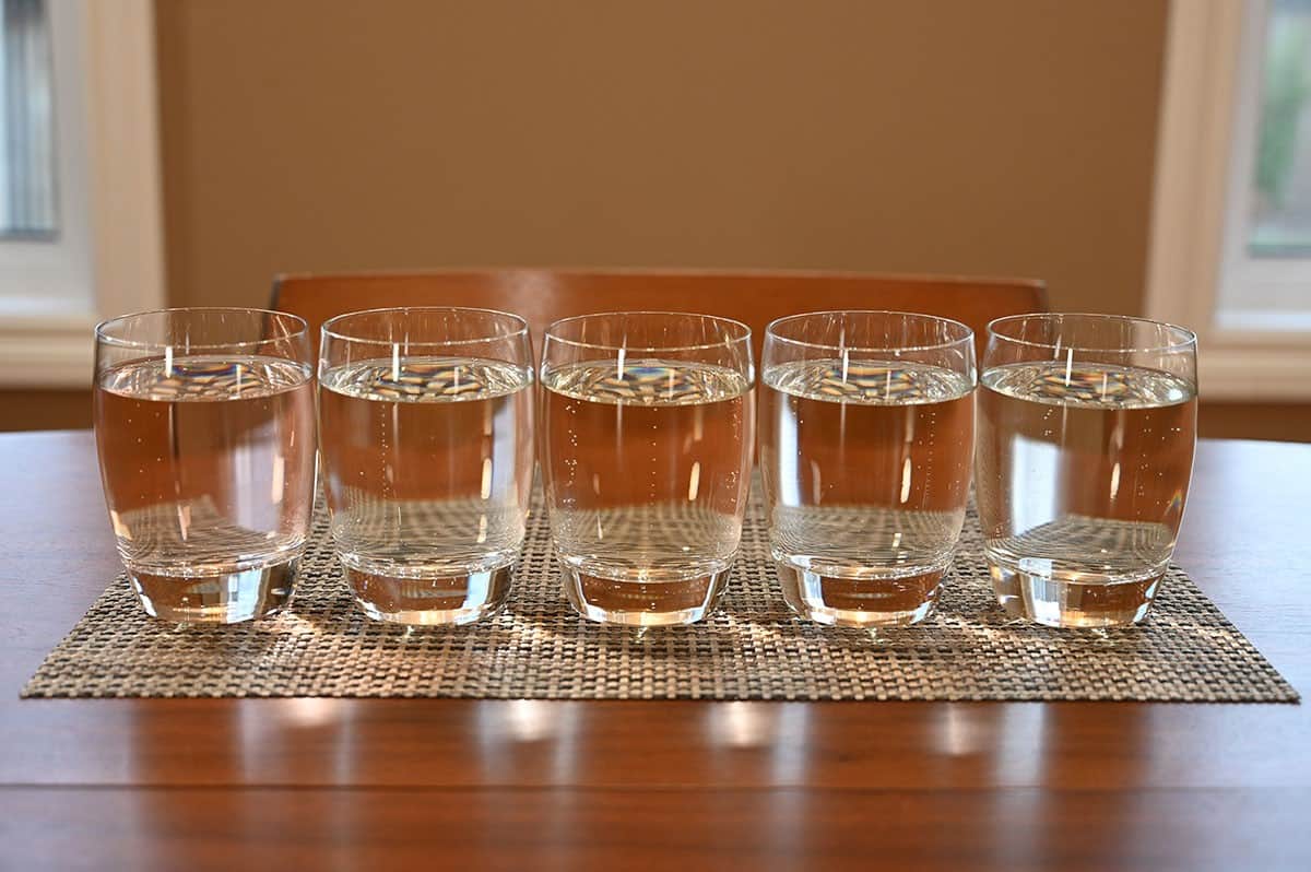 All five flavors of Costco Vizzy poured into glasses, sitting on a table. 