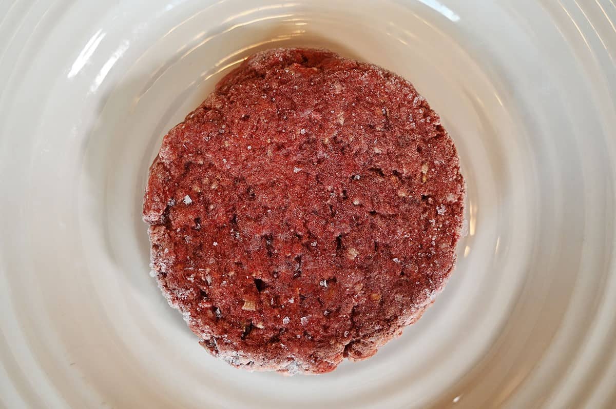Closeup image of one uncooked Costco bison burger. 