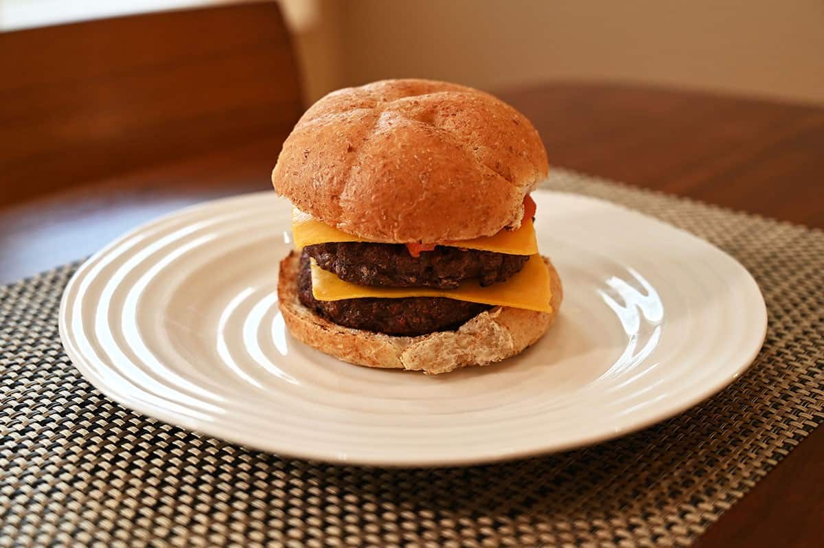 Image of a double burger with cheese on a white plate using the Image of Costco Belmont Meats Bison Burgers. 