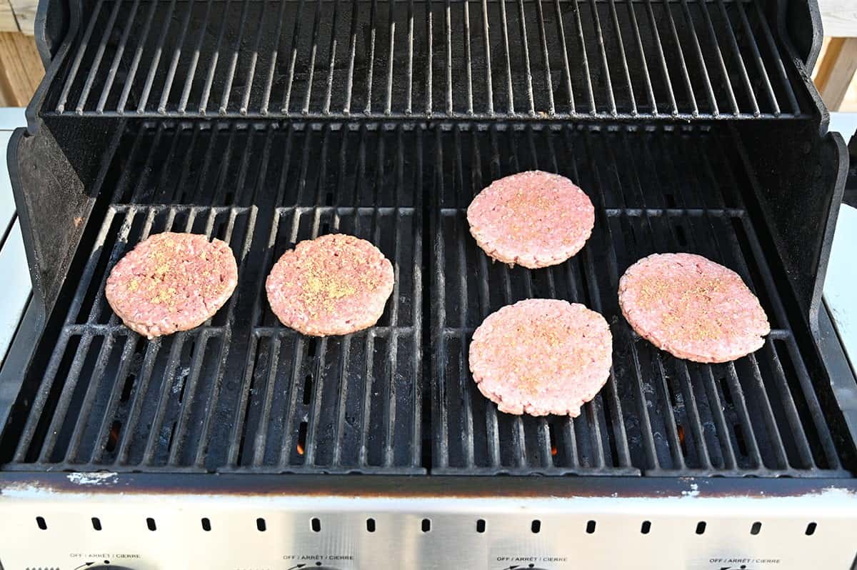 Image of five Costco Belmont Meats Bison Burgers on the barbecue being grilled.