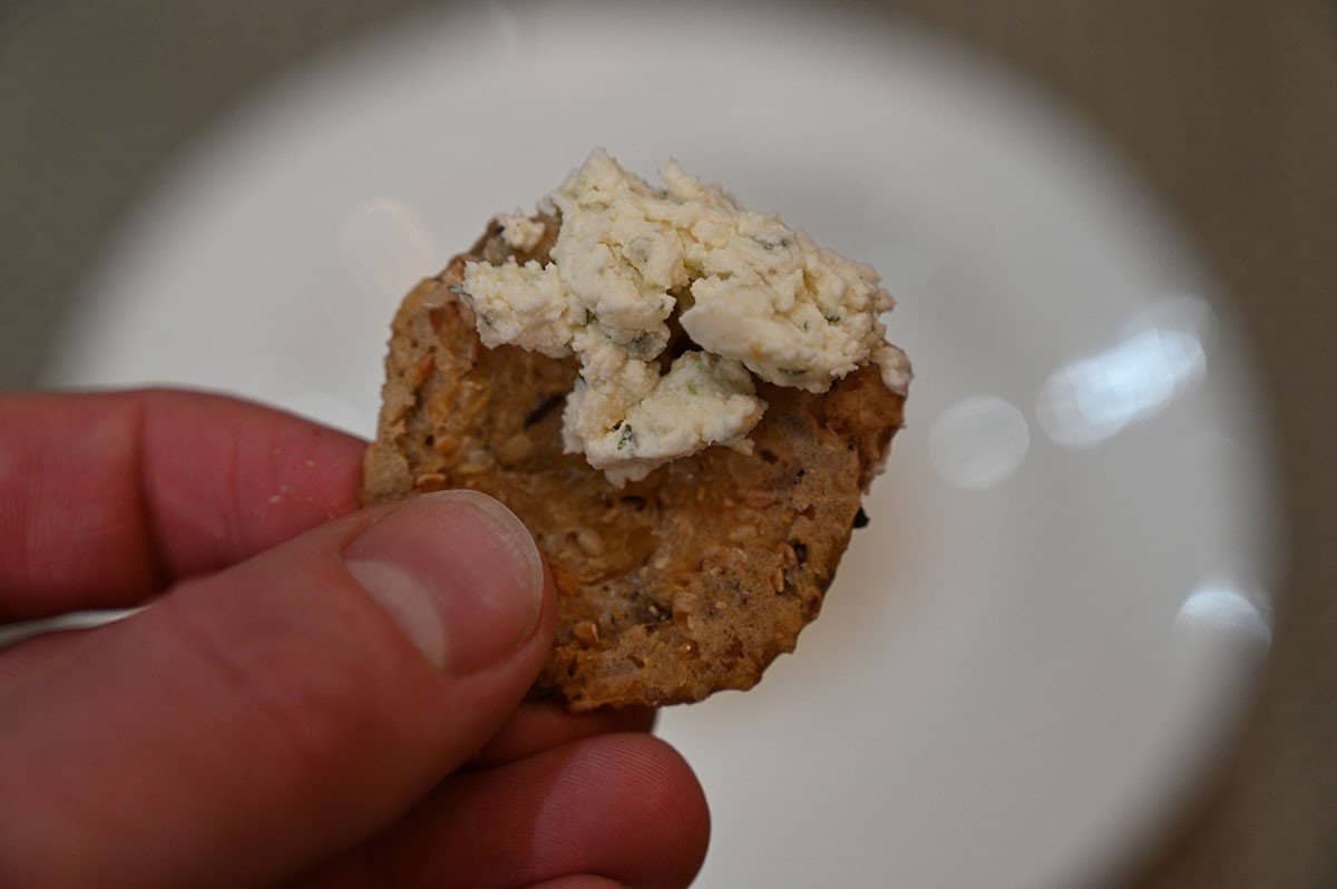 Closeup image of garlic & fine herbs flavor Boursin on a cracker. 