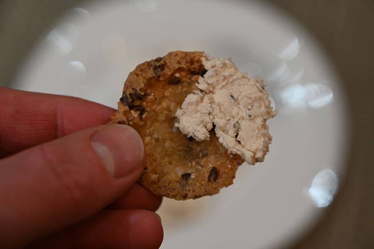 Closeup image of cranberry & pepper flavor Boursin on a cracker. 