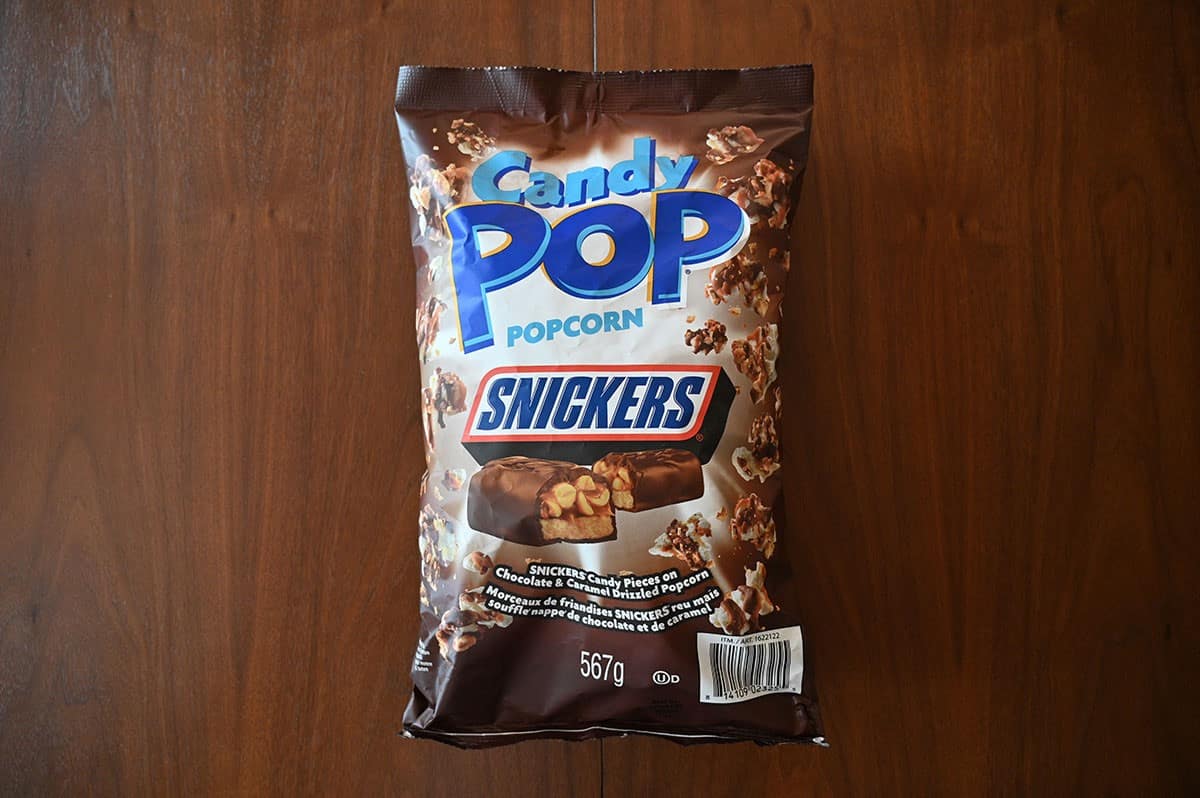 Costco Snickers Candy Pop Popcorn bag laying on a table. Top down image. 