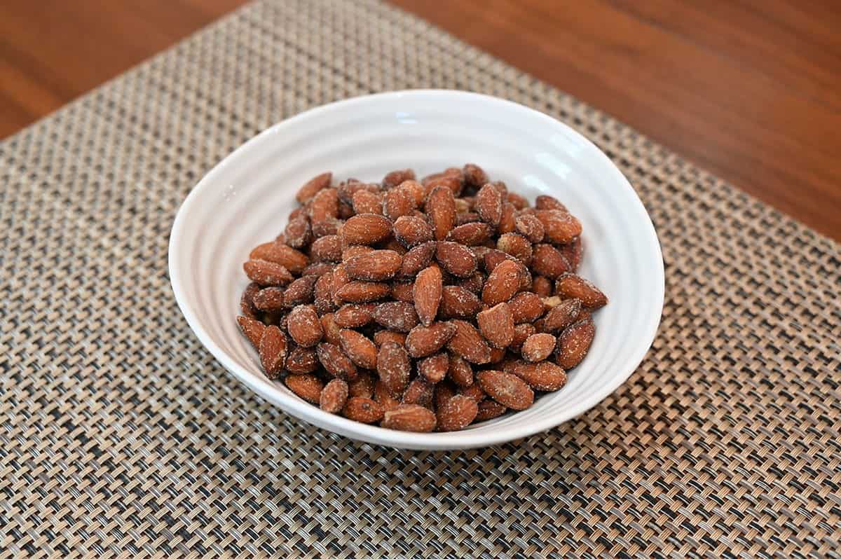 Costco Blue Diamond Spicy Dill Pickle Almonds poured into a white bowl, side view. 