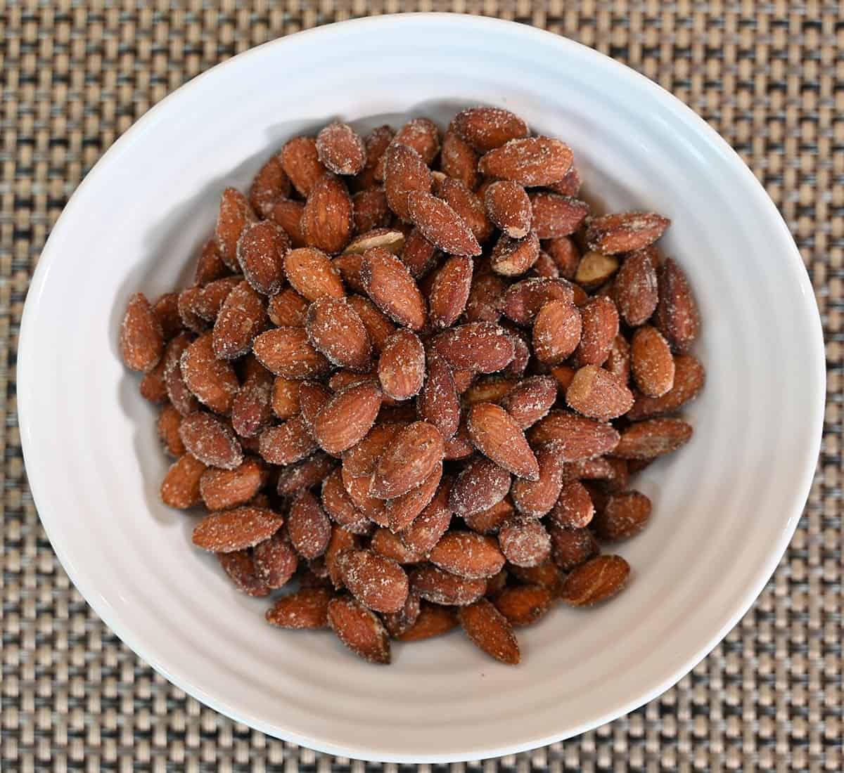 Costco Blue Diamond Spicy Dill Pickle Almonds poured into a white bowl, closeup image. 