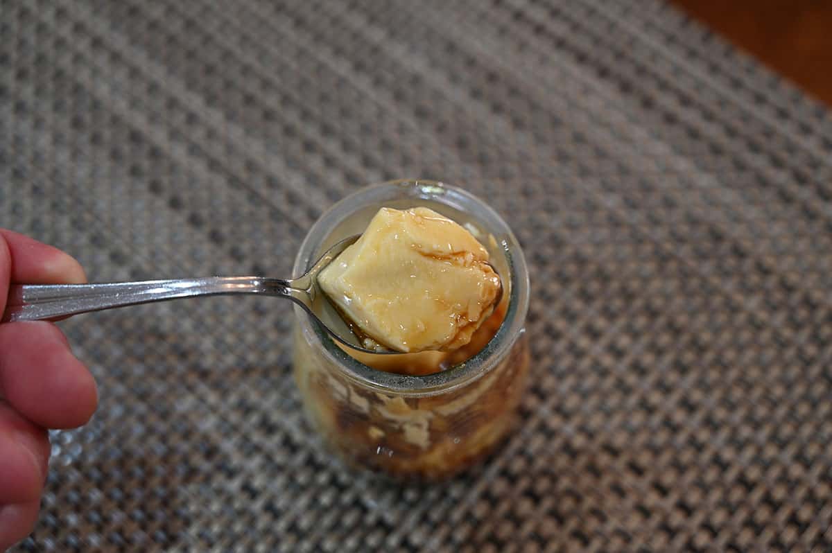 Closeup image of a spoon of Costco Marie Morin Caramel Flan. 