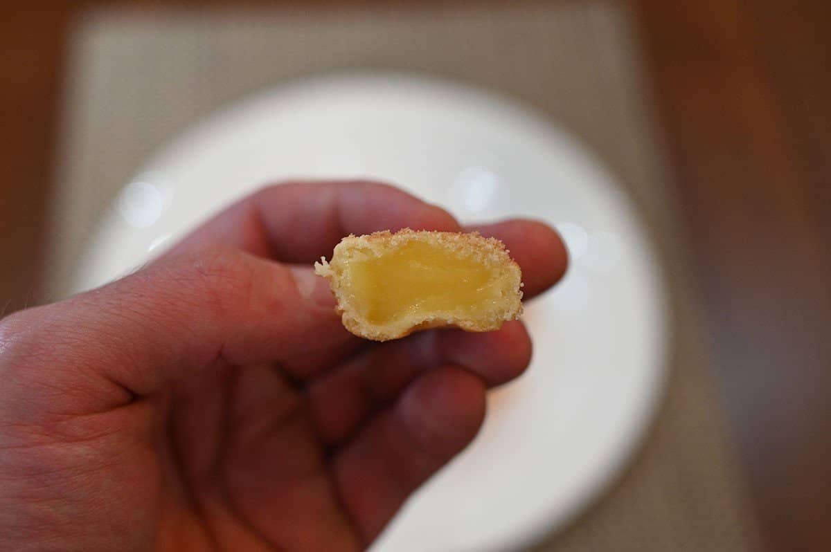 Closeup image of one Costco taiyaki with a bite taken out of it so you can see the custard. 