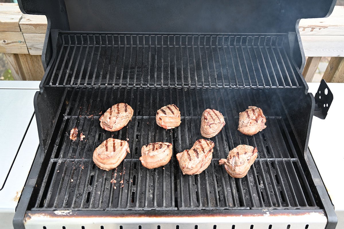 Image of eight beef Costco beef tournedos on the barbecue being cooked. 