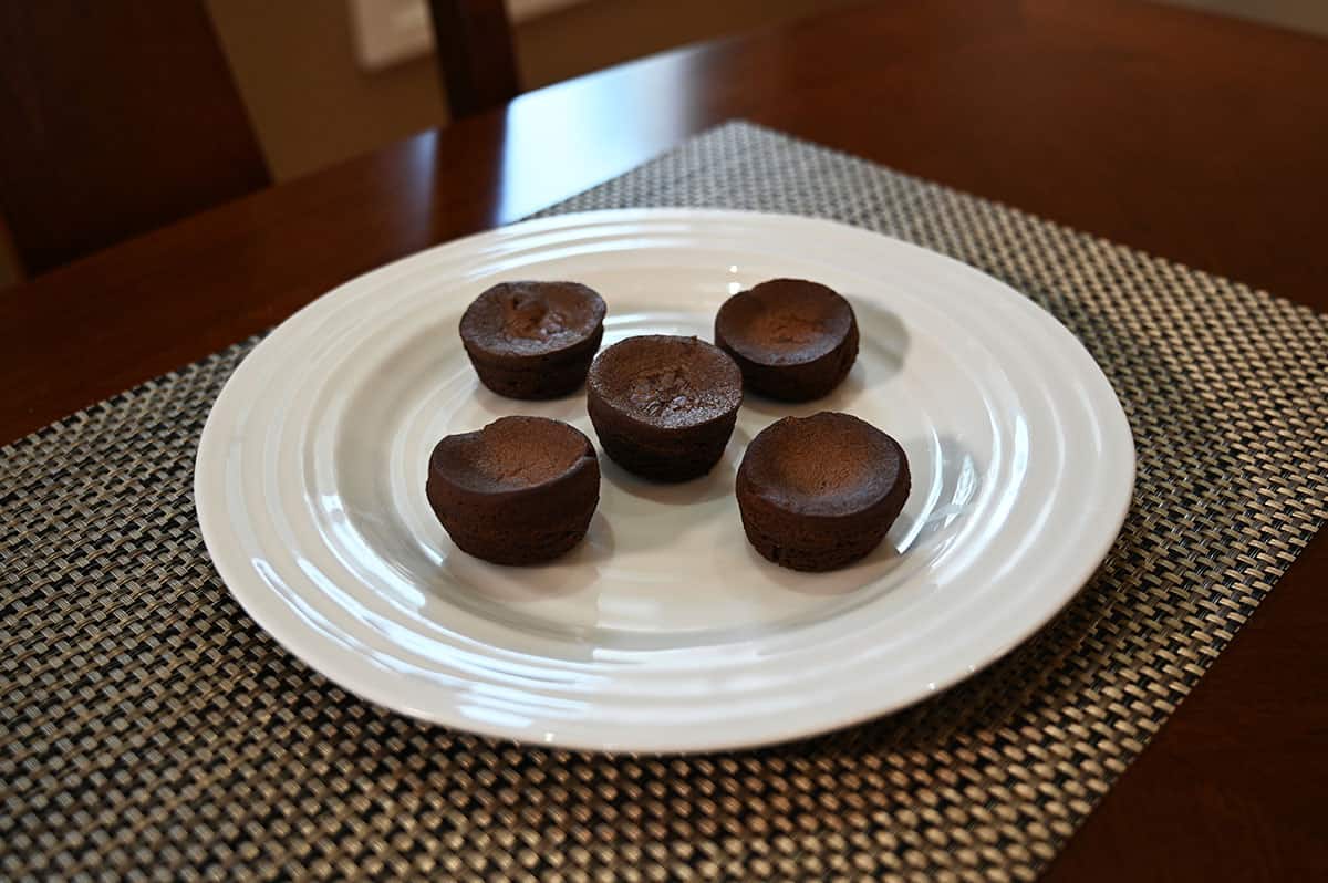 Five Costco Charlotte's Mini Chocolate Brownies served on a white plate.