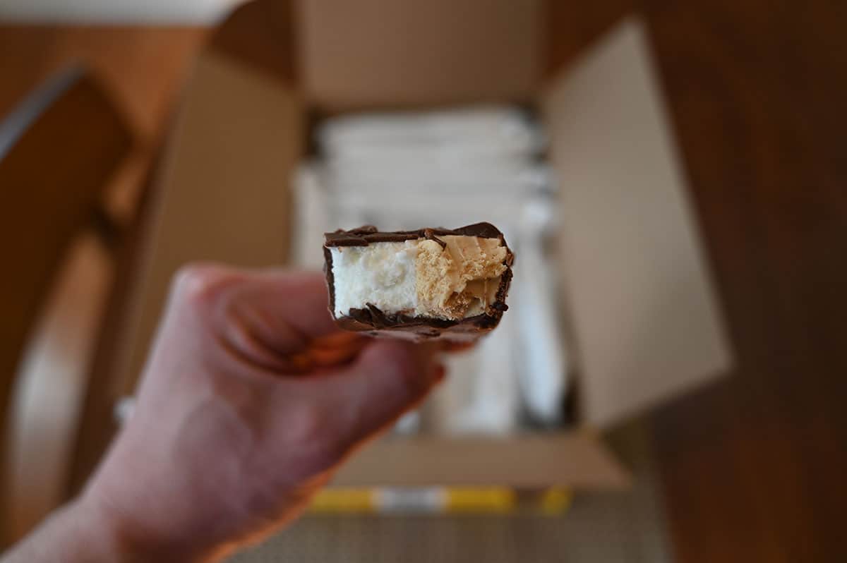 Closeup image of one Costco Nestle Coffee Crisp Ice Cream Bar with a bite taken out so you can see the inside. 