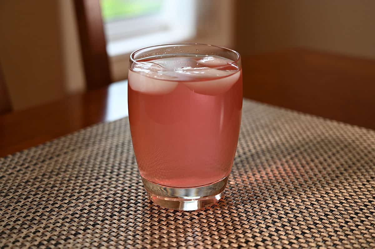 A glass of prepared Costco Good Host Raspberry Lemonade with ice in it. 