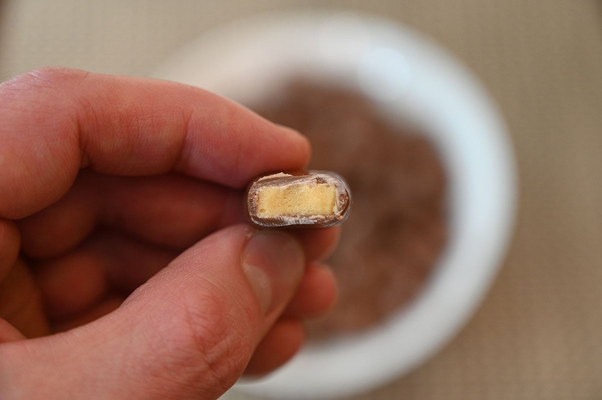 Closeup image of one Costco Waterbridge Sponge Toffee Bite with a bite taken out of it so you can see the center.